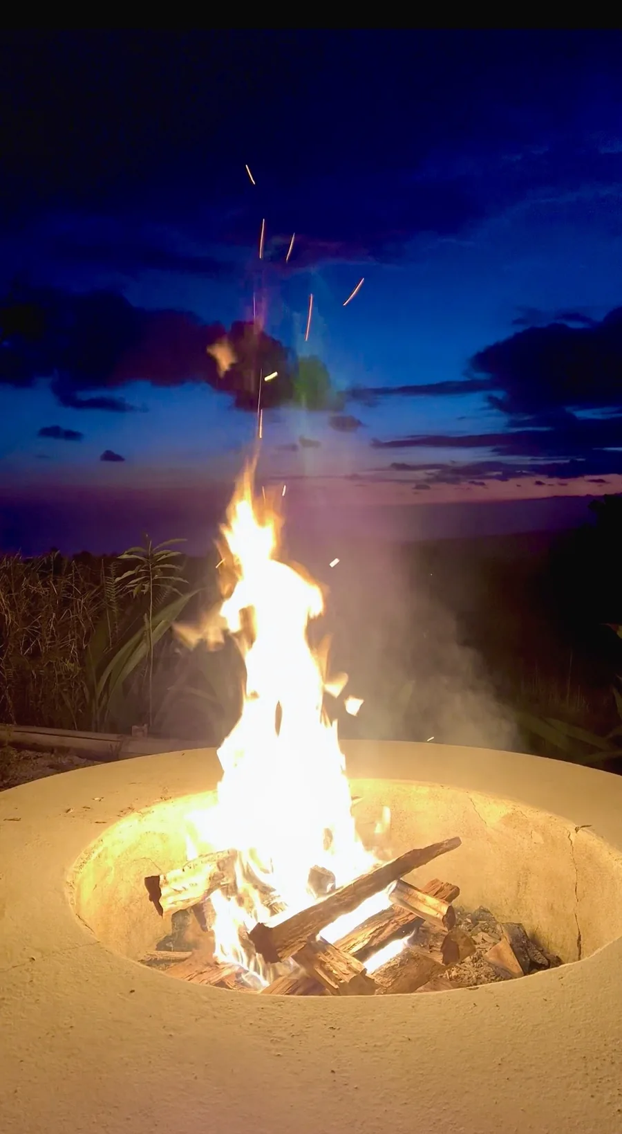 Evening fire ceremony overlooking the ocean at Wilder