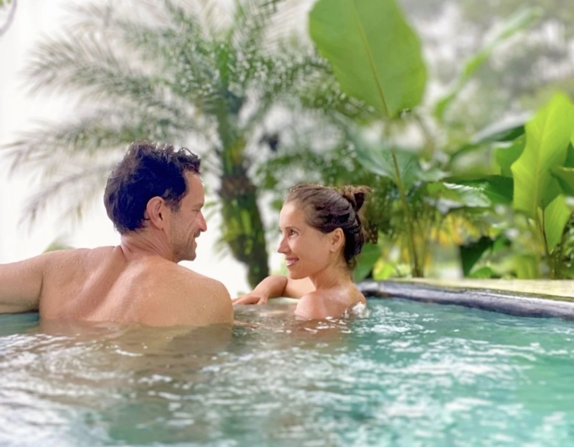 A couple sharing time in a rainforest pool