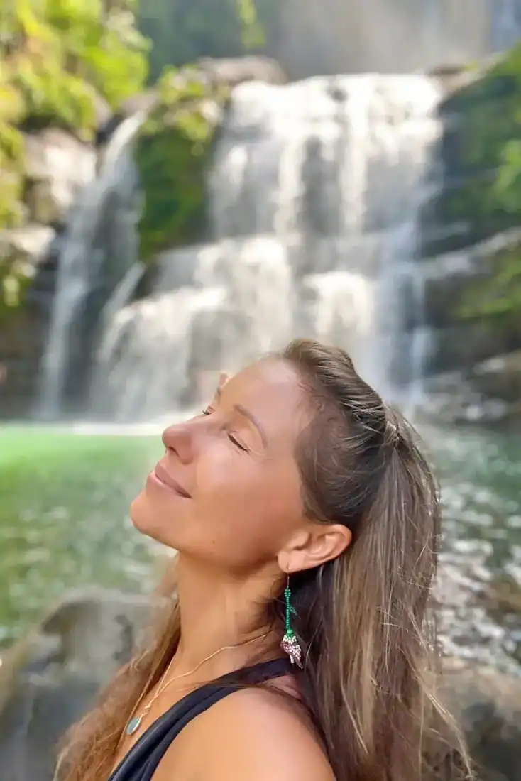 Lena experiencing the rainforest waterfall