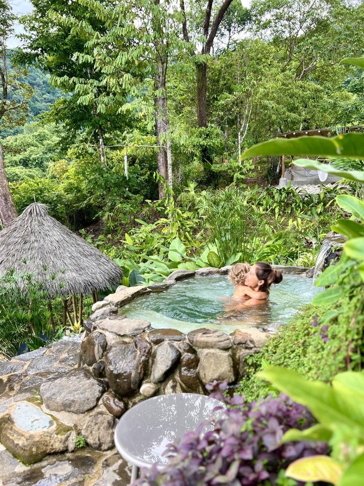 A mother and child sharing a moment in the rainforest plunge pool